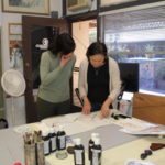 Amy and a student reviewing assessing progress on traditional cherry blossom technique
